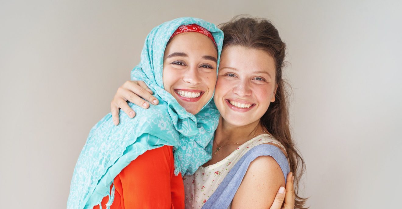 friendship of the religions concept: muslim and christian girl t